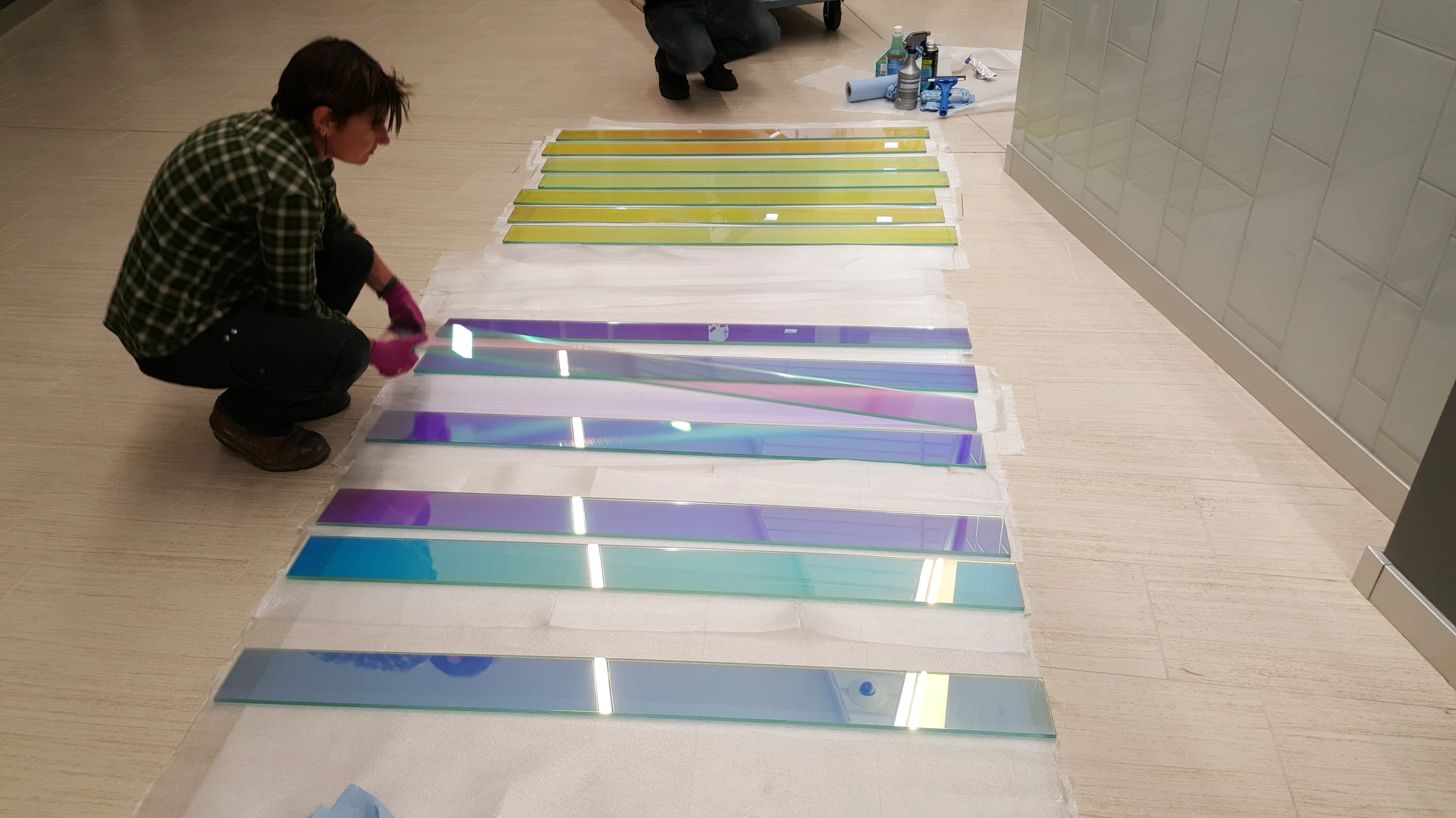 Dichroic glass elements laid out and organized during installation